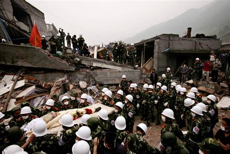 Rescuers carry a survivor from the rubble of a collapsed building in Yinghua town in southwest China's Sichuan province on Friday. www.msnbc.msn.com 